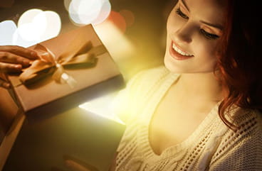 A women opening a gift box.