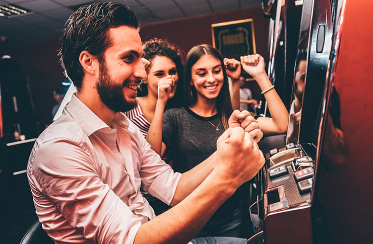 Casino guests enjoying a slot game.