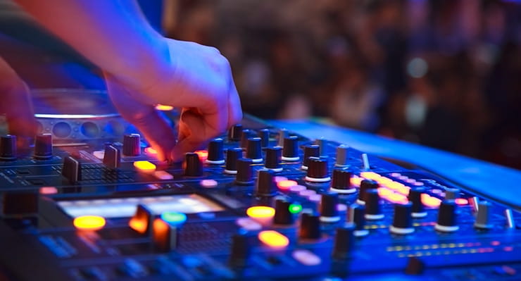 A DJ playing in front of a crowd.