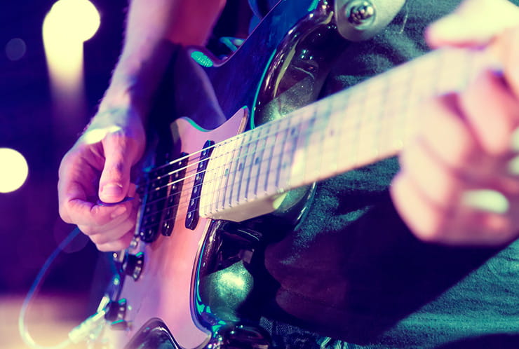 A man playing a guitar.